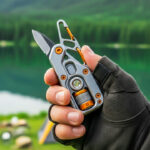 A detailed flat lay of essential everyday carry (EDC) survival gear, including a multi-tool, compass, tactical flashlight, fire starter, and portable power bank, displayed on a dark, rugged surface.